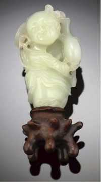 19th/20th century A greenish white jade carving of a standing boy